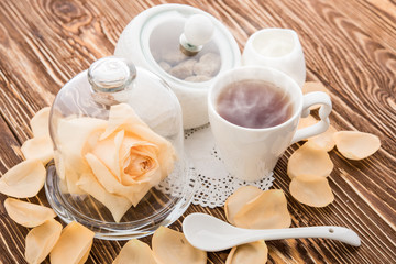 Tea cups with teapot on old wooden table