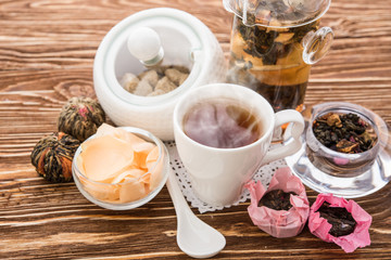 Tea cups with teapot on old wooden table