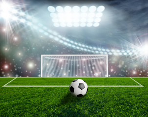 Soccer ball on green stadium arena