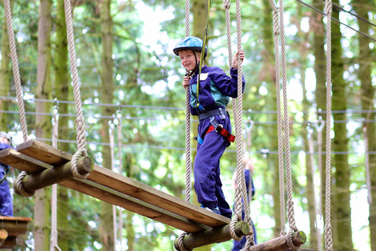 Happy Kids Climbing In Adventure Park