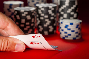 poker game. man's hand with a pair of aces
