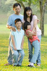 Fototapeta premium Asian Family Enjoying Walk In Summer Countryside