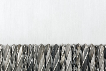 Drill bits on metal background
