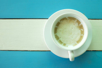 cup of  coffee on the wooden table, top view