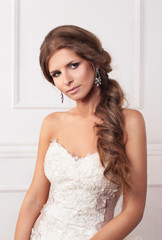 beautiful girl the bride on a background of bright stucco