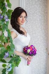Bride near the blossoming vines