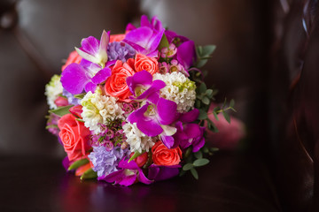 Purple bridal bouquet of the bride, on a brown background
