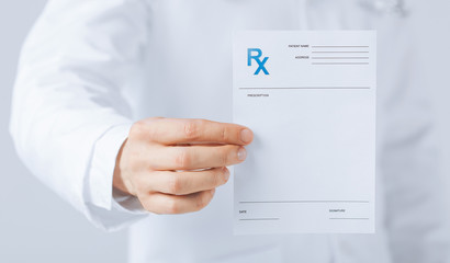 male doctor holding rx paper in hand - obrazy, fototapety, plakaty