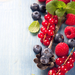 Berries and vintage spoon on a blue background