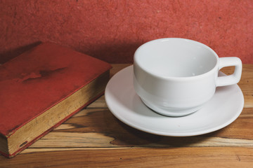 Empty coffee cup and old book on a wooden, Process color with Vi
