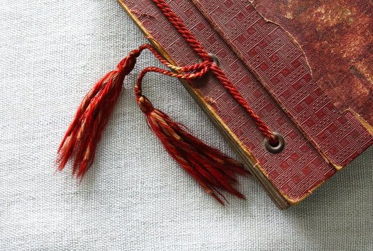 Old Red Photo Album With Tassels On Canvas Background