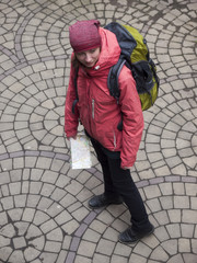 Girl with a backpack and a map.