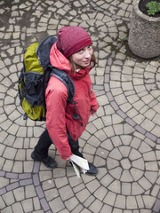 Girl with a backpack and a map.