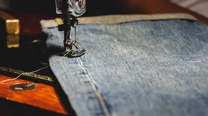 Sewing and jeans, Process color, Selective focus.