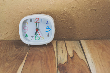 Clock on a wooden. Process color with vintage tone.