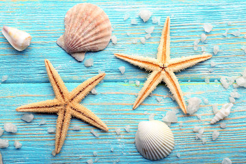 Fototapeta na wymiar Sea stars and shells on wooden background