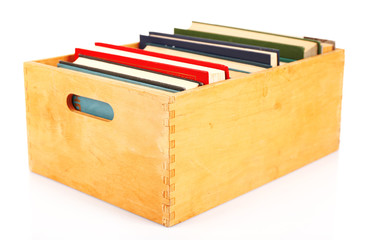 Books in wooden box isolated on white