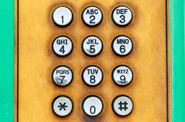 Numeric keypad of public telephone.