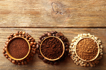 Various of coffee in small dishes on wooden table, top view