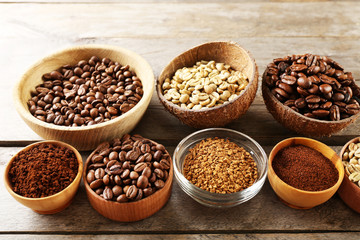 Various of coffee in small dishes on wooden background