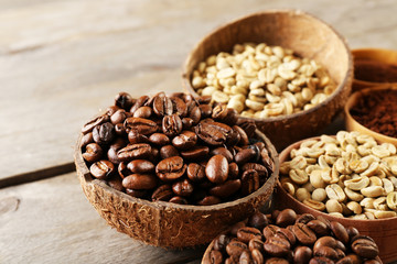 Various of coffee in small dishes on wooden table, closeup
