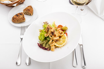 Delicious fried calamari in restaurant