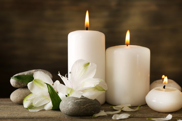 Plakat Beautiful composition with candles and spa stones on wooden background
