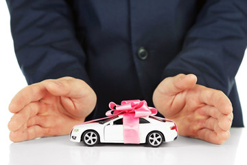 Man and model of car on table, closeup