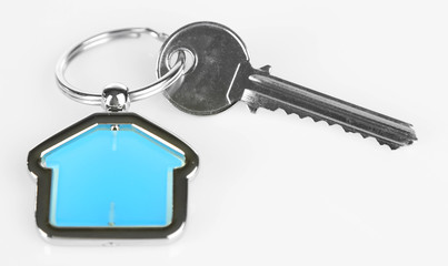 Keys with trinket on light background