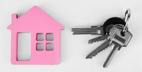 Keys with trinket on light background