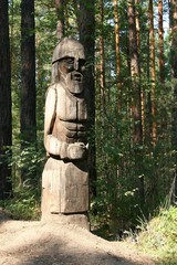 Fototapeta na wymiar The sculpture is made of wood. Wooden idol in the forest.