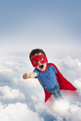 superhero boy flying in the sky