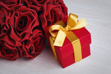 red flowers and gift box with yellow ribbon
