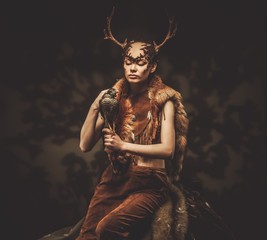 Woman shaman in ritual garment with hawk