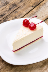 New York style cheesecake with pair of dessert cherries