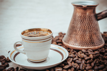 Coffee turk and roasted beans on burlap background.