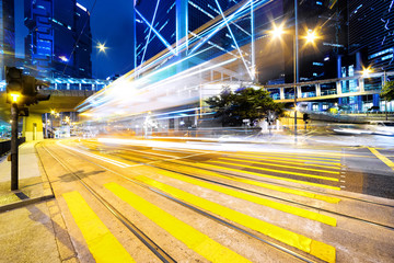 traffic light trails and office buildings in modern city