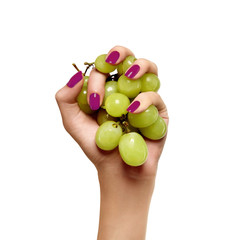 beauty female hand with green grapes  on a white background