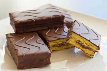 Sliced sponge cake in chocolate