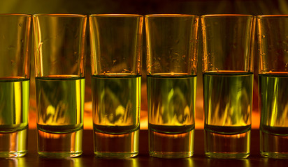 Burning cocktails in shot glass on a table, tequila