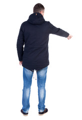 Naklejka premium Back view of pointing young men in parka.