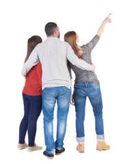 Back view of three friends pointing.