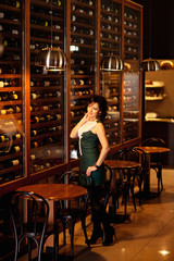 Middle-aged woman standing near wine room