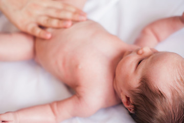 Mother makes nursing baby massage