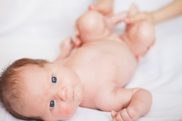 Newborn baby lying on a white background