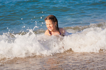 Happy kid playing playing on beach