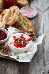 delicious appetizers - camembert with berry jam, toast and fruit