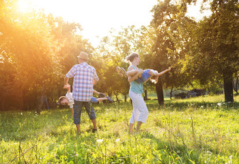 Fototapeta premium Happy young family spending time together outside in nature