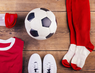 Various football stuff lined up on a wooden floor background - Powered by Adobe