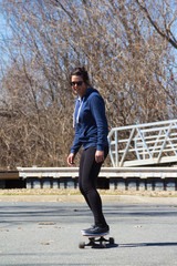 woman riding longboard skateboard outdoor